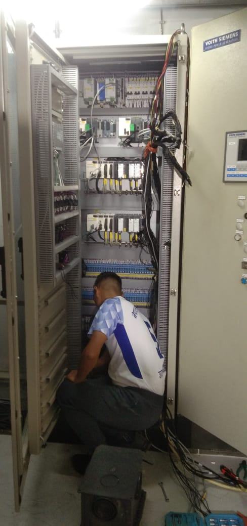 Engineer commissioning wiring inside the digital governor cabinet