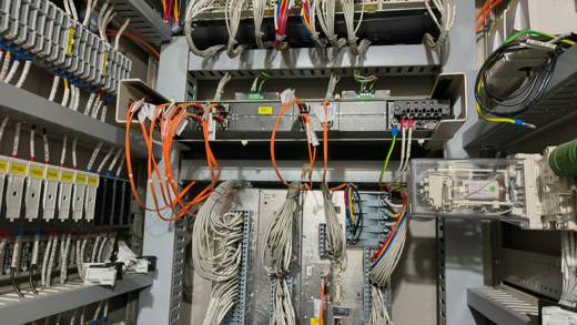 Fiber optic cables and communication equipment inside a control panel